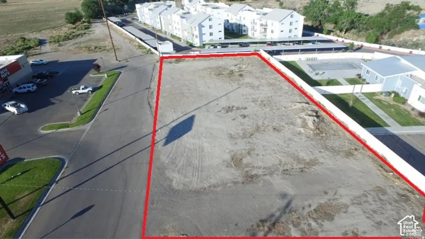 Unimproved lot with perimeter bordering an asphalt road and adjacent to developed properties