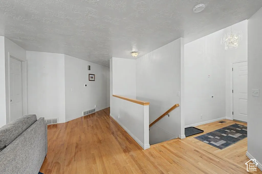 Hardwood flooring throughout, white painted walls.