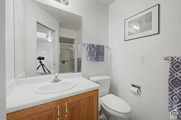 Vanity with a laminate countertop, integrated sink, and wood-finish cabinetry