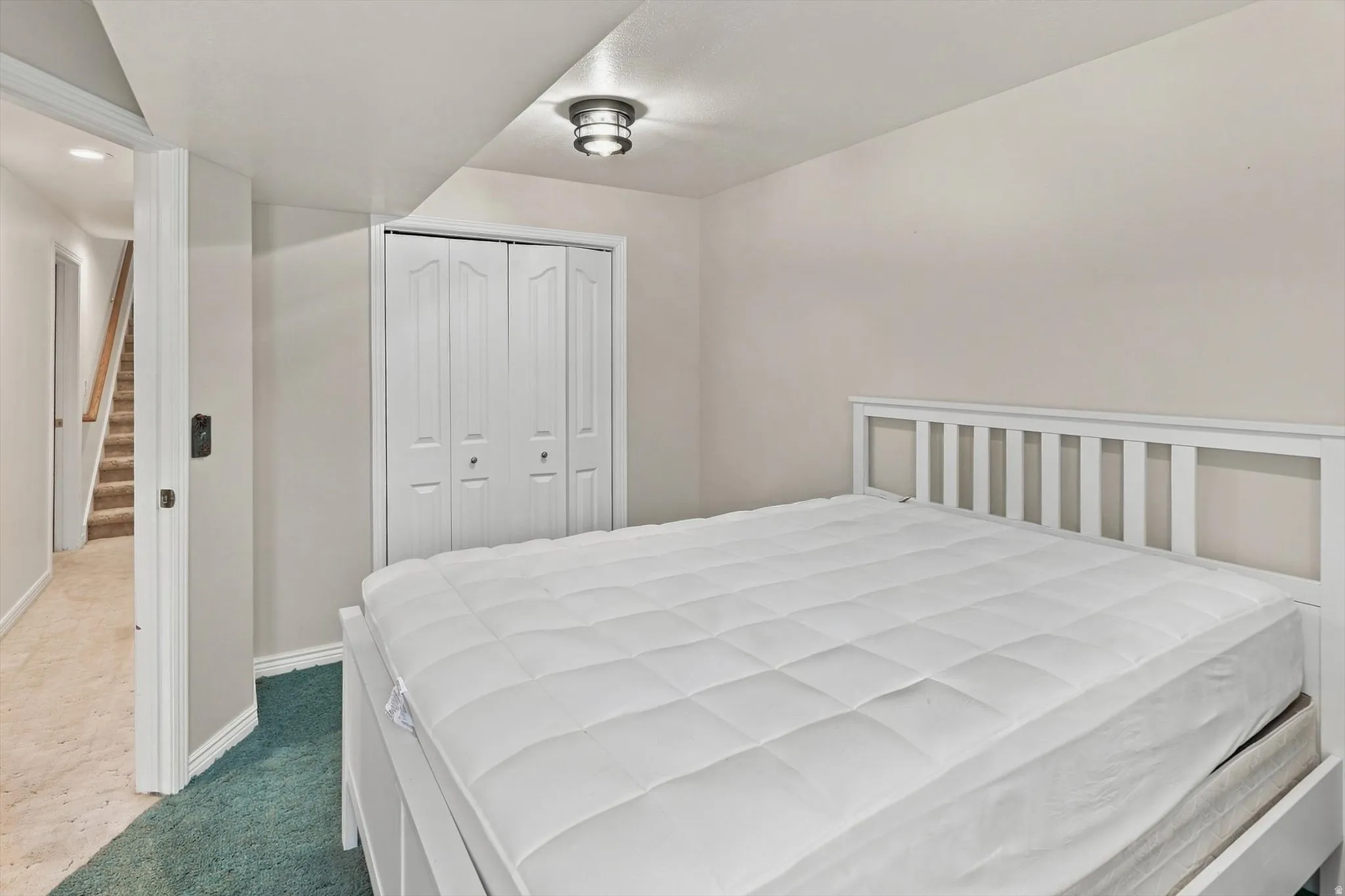 Recessed ceiling lighting, white bi-fold closet doors, and light-toned walls