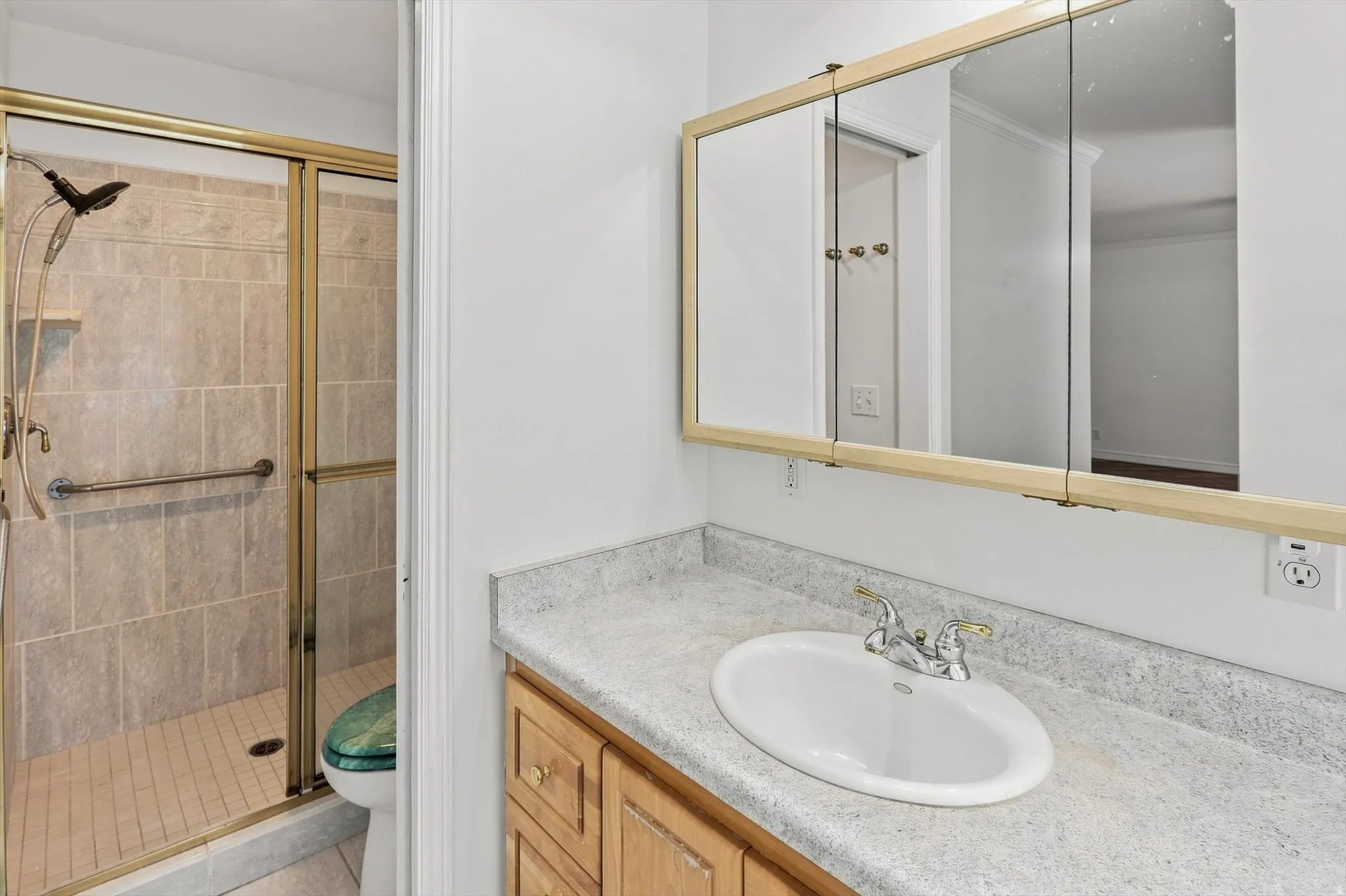 Vanity with an integrated sink, laminate countertop, and wood-finish cabinetry