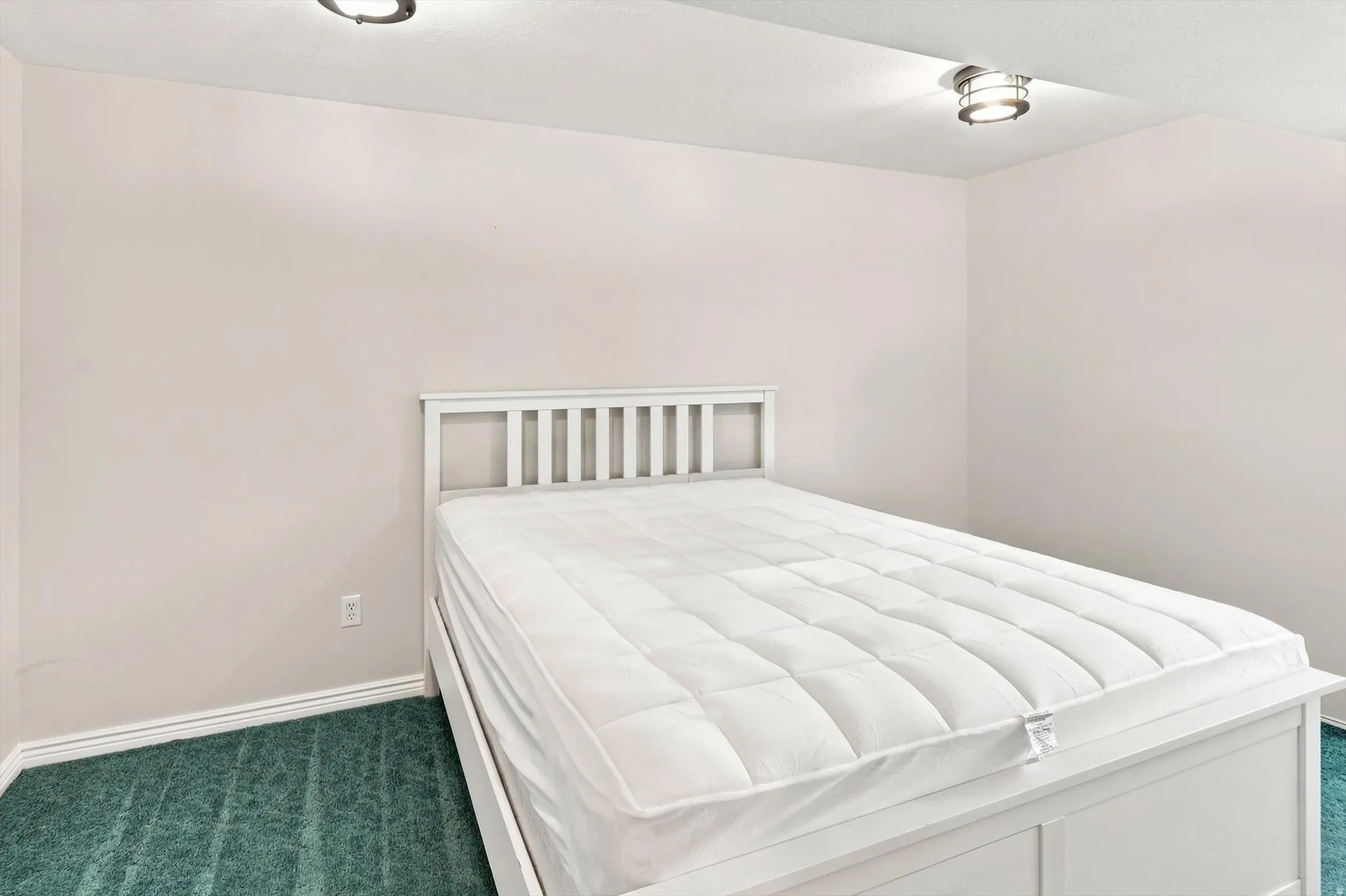 Recessed lighting and ceiling-mounted fixture illuminate the space