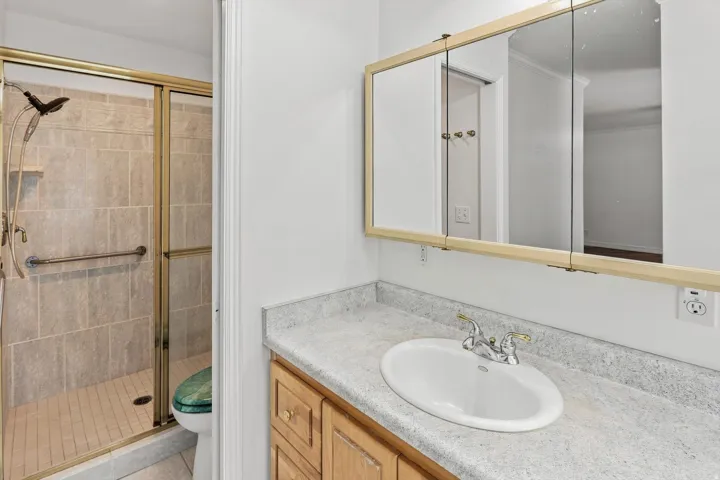 Vanity with an integrated sink, laminate countertop, and wood-finish cabinetry
