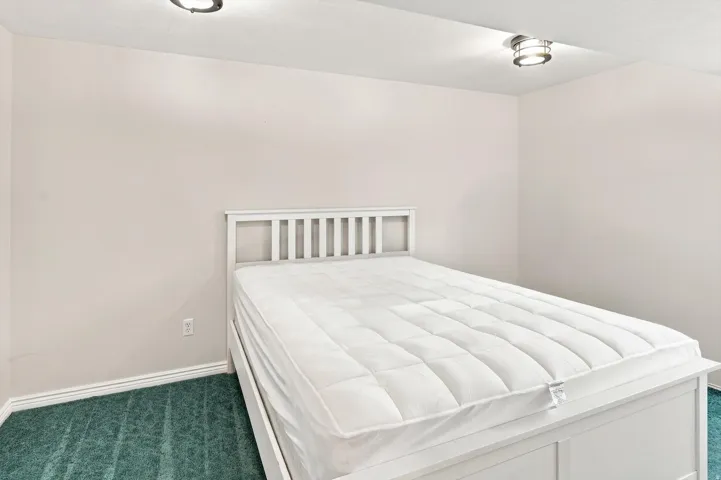 Recessed lighting and ceiling-mounted fixture illuminate the space
