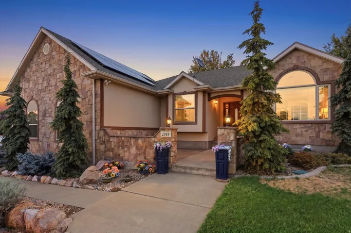 Stone and stucco exterior, arched windows, covered entry, front porch, solar panels