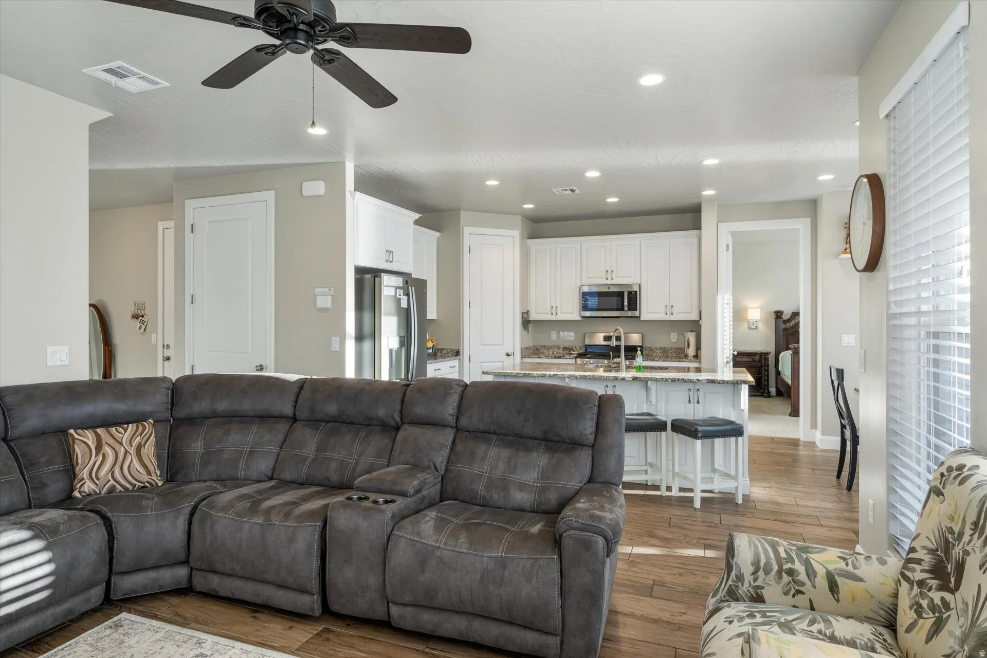 Open concept living area with wood-finish flooring