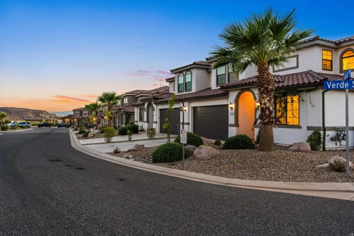 Mediterranean-style architecture with arched entryways, tile roofing, and integrated garages