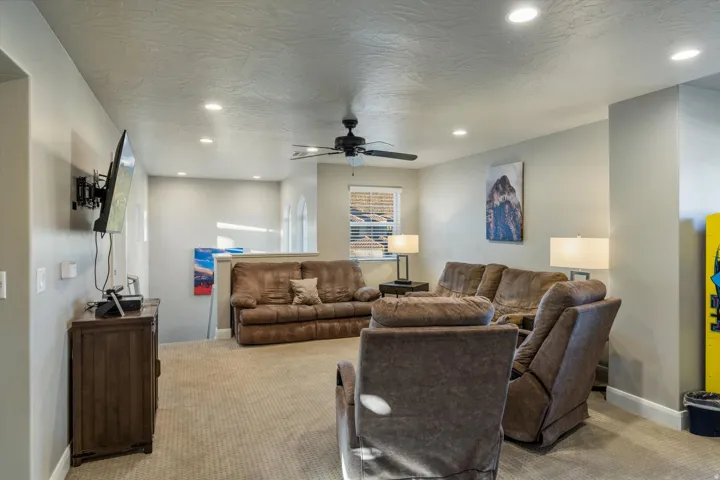 Recessed lighting, ceiling fan, and carpeted flooring