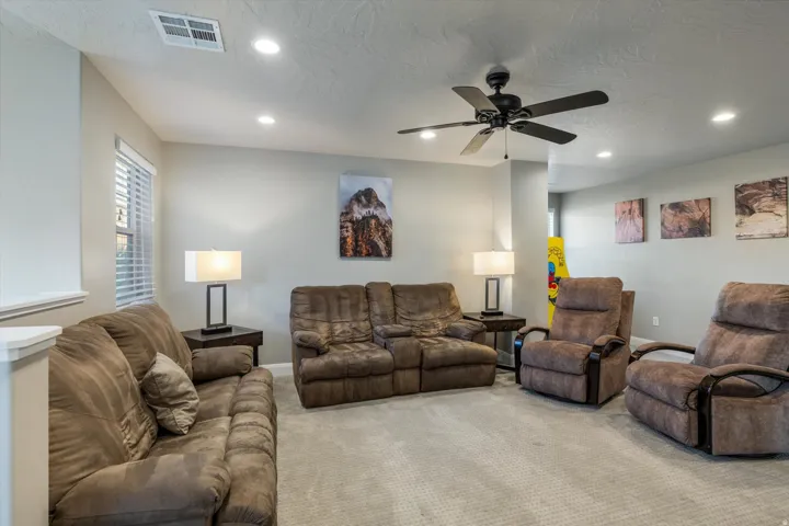 Recessed ceiling lighting, ceiling fan, window with blinds, and light-toned wall paint
