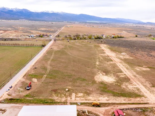 Expansive undeveloped land featuring a long private road and distant mountains
