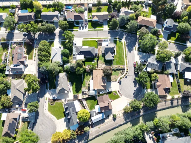 Residential neighborhood with established homes, mature trees, and paved streets