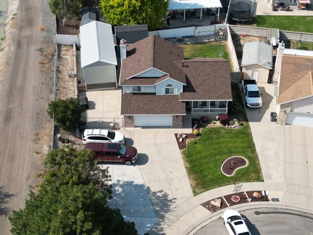 Two-story residence with a two-car garage, mature landscaping, and a covered porch