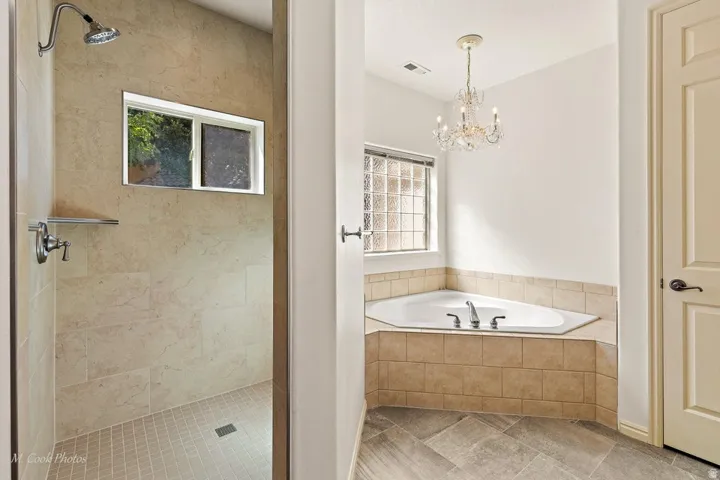 Walk-in shower with large format tile walls and a window