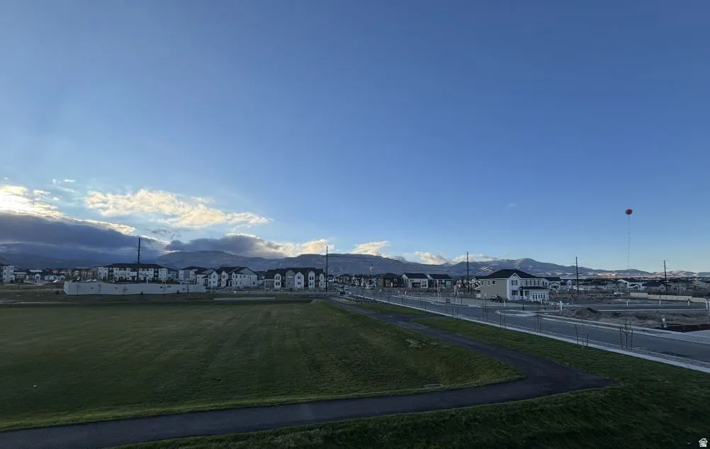 Expansive green space with a paved walking path