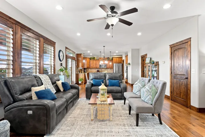 Hardwood flooring throughout, recessed lighting, and a ceiling fan