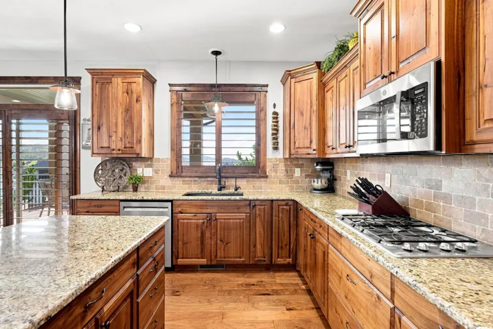 Wood-finish cabinetry paired with light-toned granite countertops