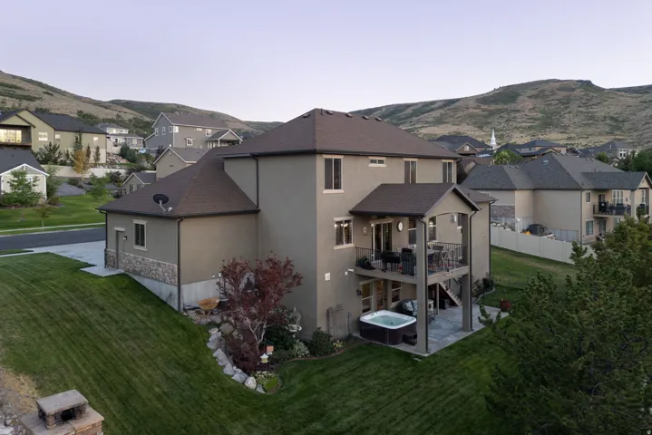 Stucco exterior with stone accenting and a multi-level deck