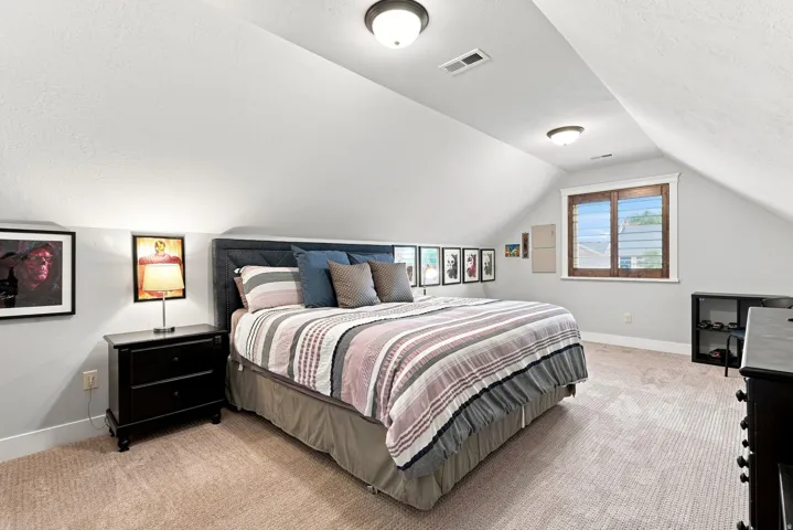 Upstairs bedroom #2. Carpeted room featuring a sloped ceiling, recessed lighting, and a window with wood-finish blinds