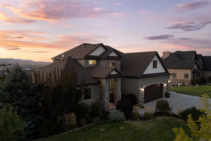 Stone and siding exterior with dark trim accents