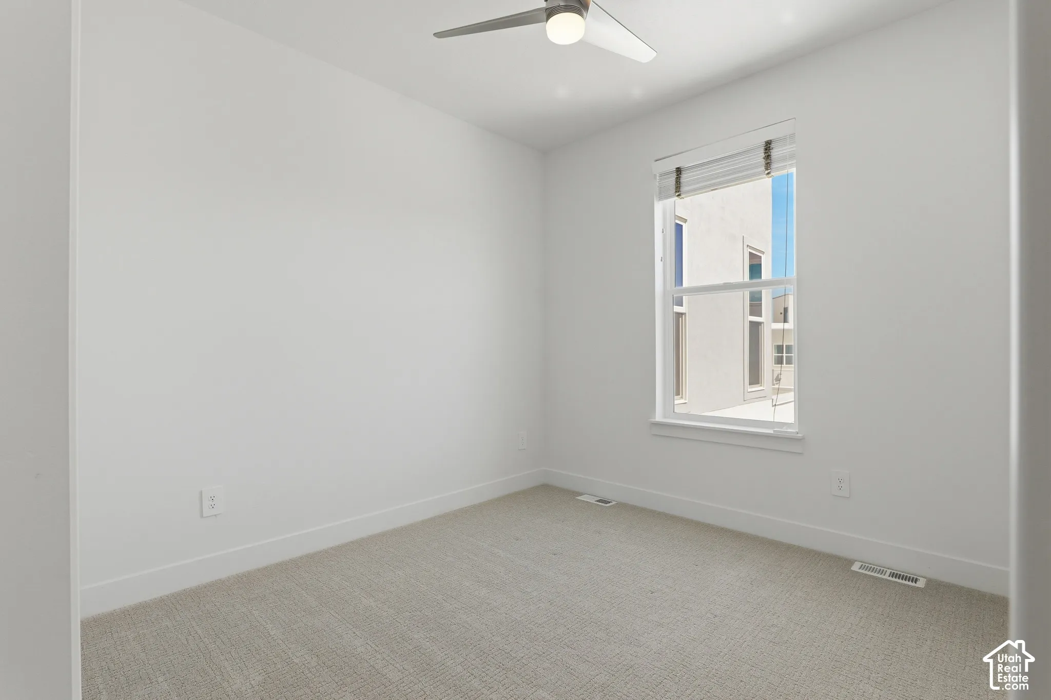 Recessed lighting, ceiling fan, and window with blinds