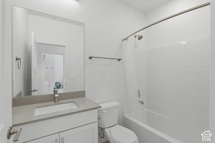 White vanity with brushed nickel hardware, light-toned countertop, and undermount sink