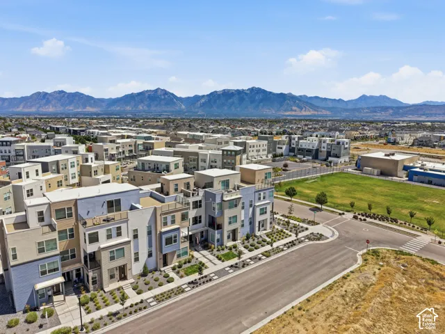 Modern multi-story residential architecture with varied exterior finishes and multiple balconies