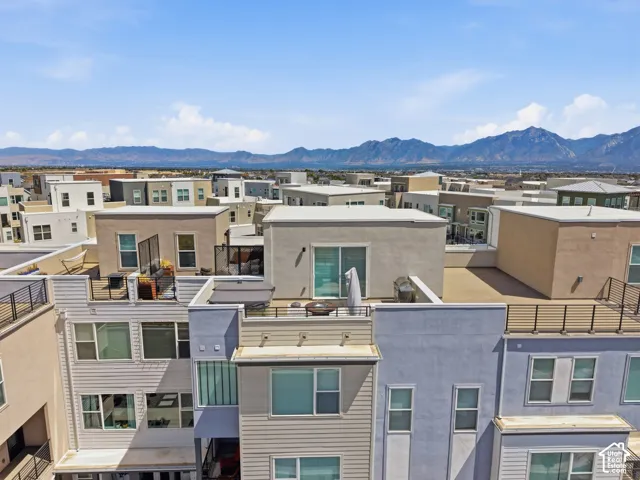 Rooftop patio with metal railings and a distant mountain backdrop
