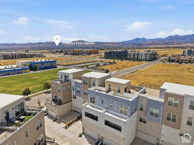 Townhome architecture featuring multiple balconies, rooftop terrace, and attached garage