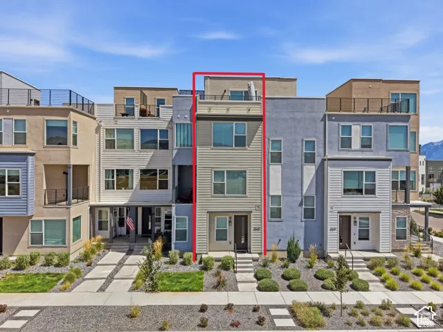Modern exterior with vertical siding, multiple windows, and a rooftop deck