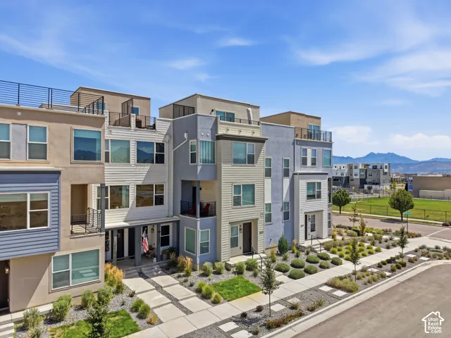 Modern townhome architecture with multiple balconies and rooftop deck access