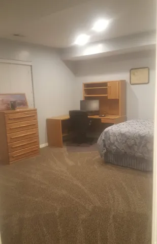 Wall-to-wall carpeting with light gray wall paint