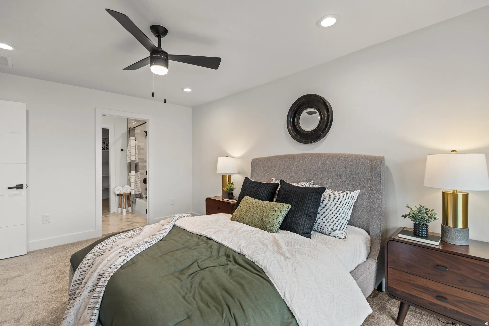 Recessed lighting, ceiling fan with integrated light, and clean white walls