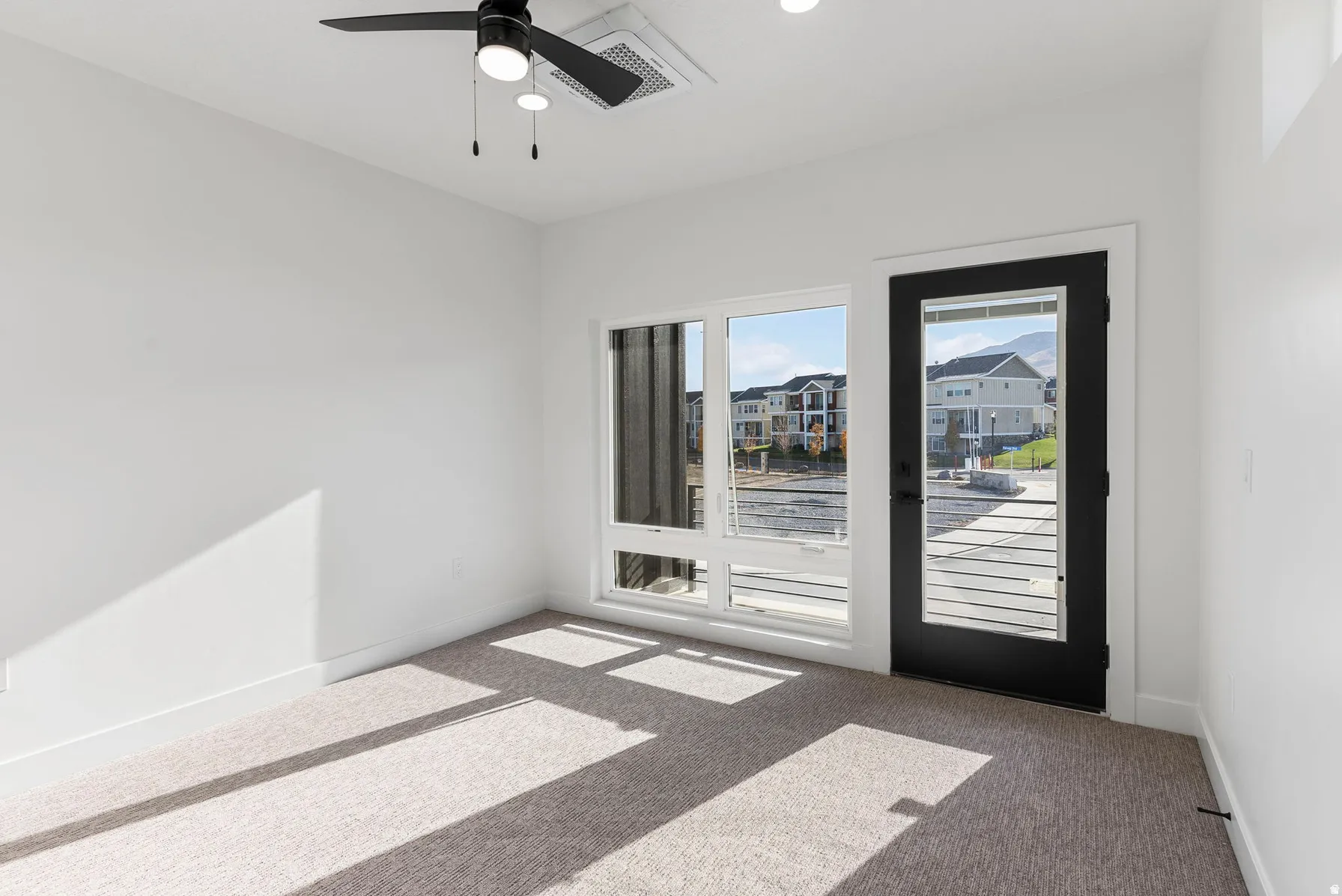 White walls featuring a black ceiling fan, recessed lighting, and carpeted flooring