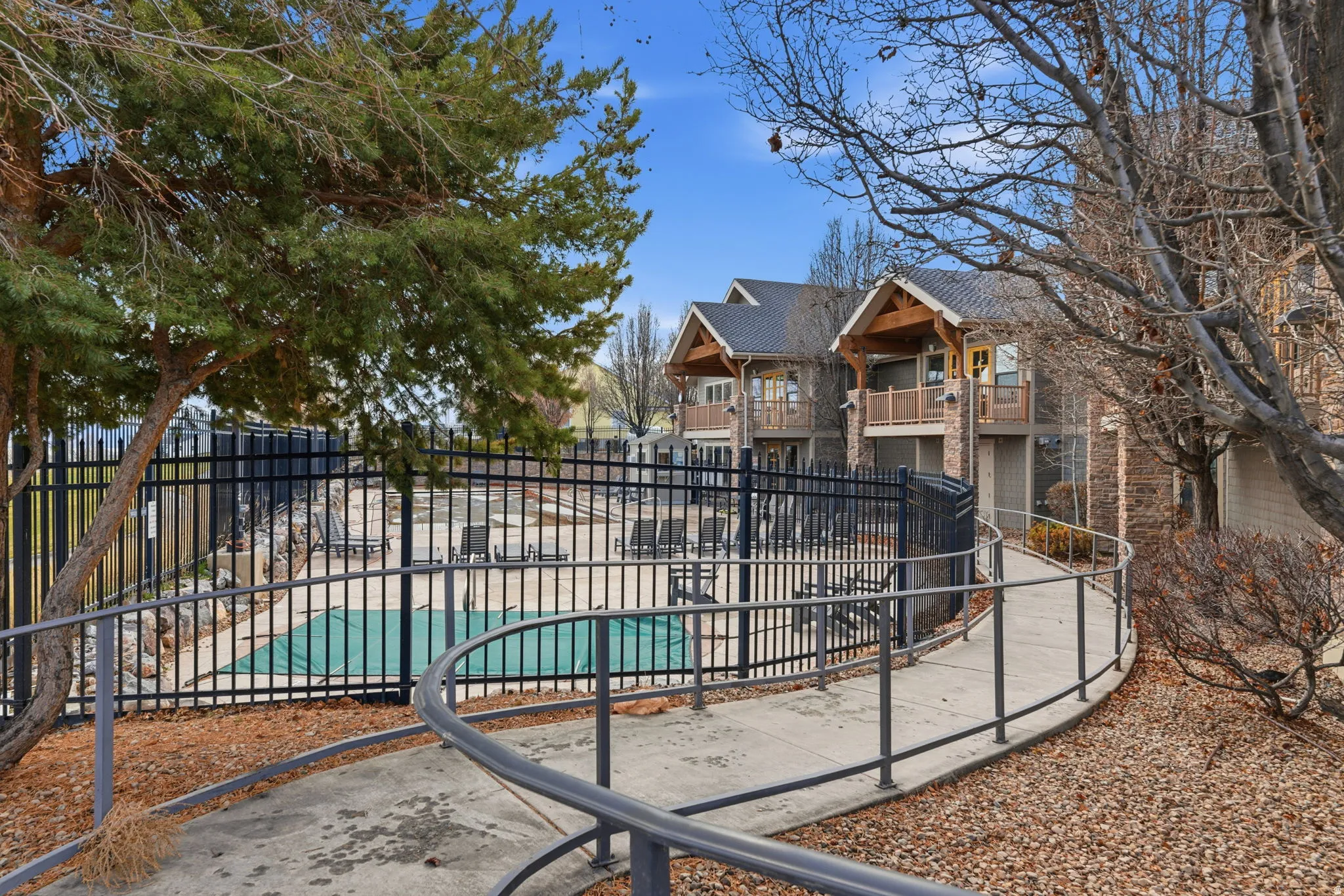 Community pool with perimeter fencing and an accessible ramp