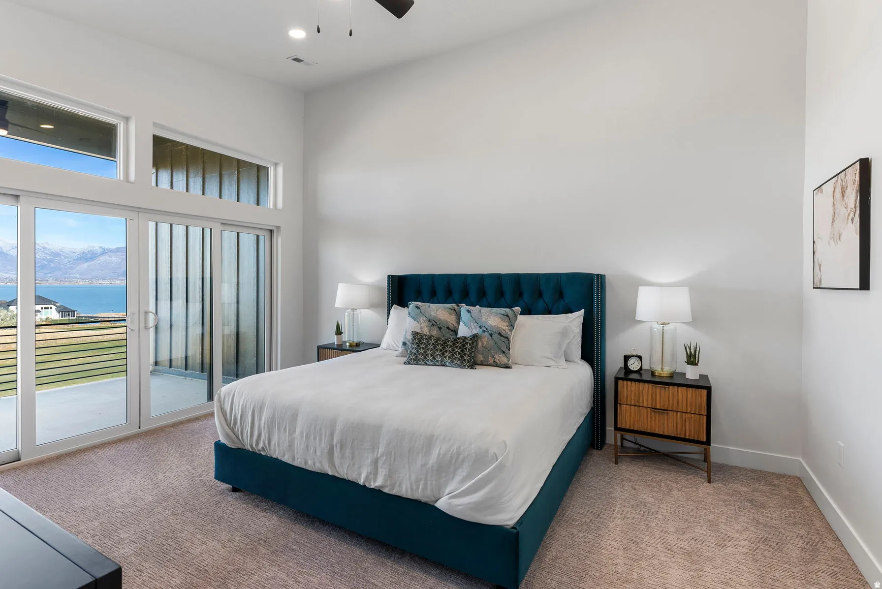 Lake and mountain scenery, sliding glass doors, transom windows, recessed lighting, and a ceiling fan