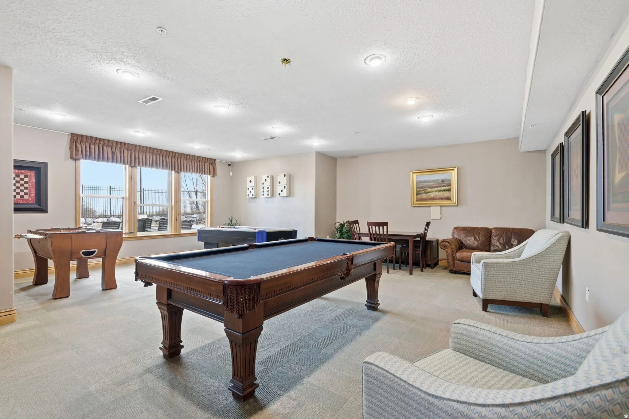 Recreation room featuring carpeted flooring and recessed lighting
