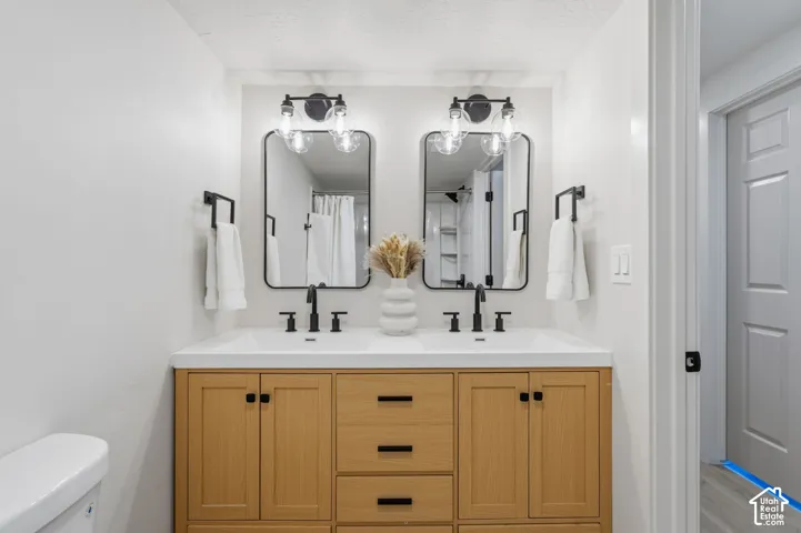 Dual vanity with wood-finish cabinetry and black hardware