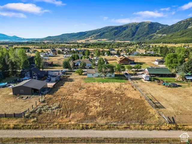 Expansive undeveloped land parcel with surrounding residential properties, defined by fencing
