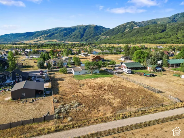 Expansive parcel featuring a perimeter fence and mountain backdrop