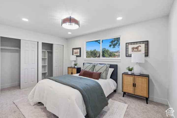 Recessed lighting, a central semi-flush mount fixture, and a large window provide ample illumination
