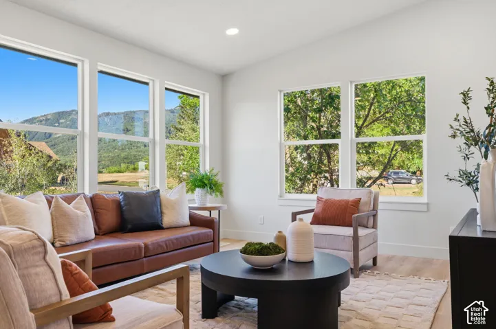 Expansive windows, recessed lighting, and wood-finish flooring