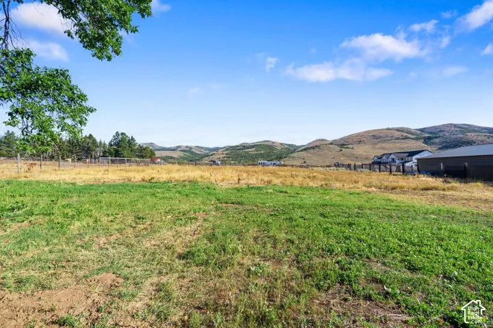 Expansive open land with rolling hills in the background