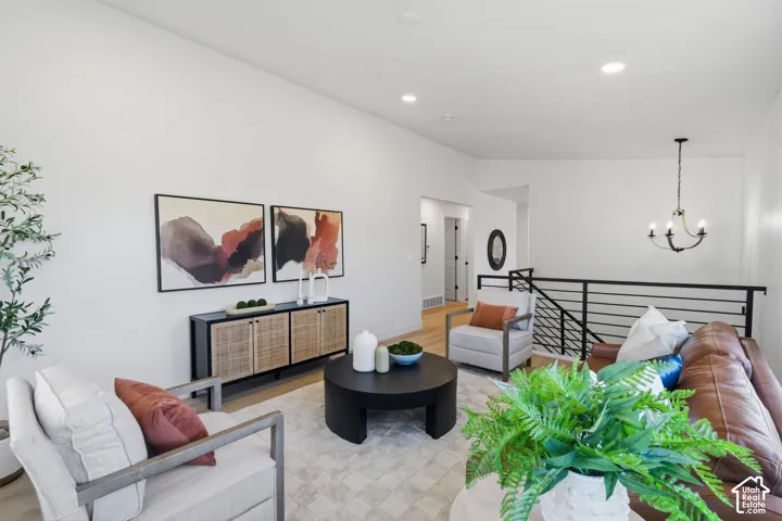 Spacious living area featuring high ceilings, recessed lighting, and a modern chandelier