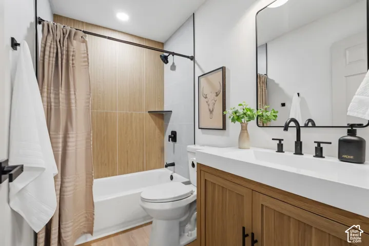 White vanity with wood-finish cabinetry and matte black hardware
