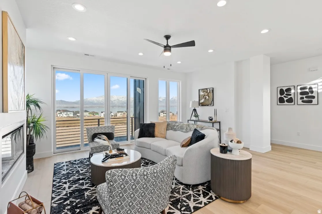 Expansive sliding glass doors, recessed lighting, and a modern ceiling fan