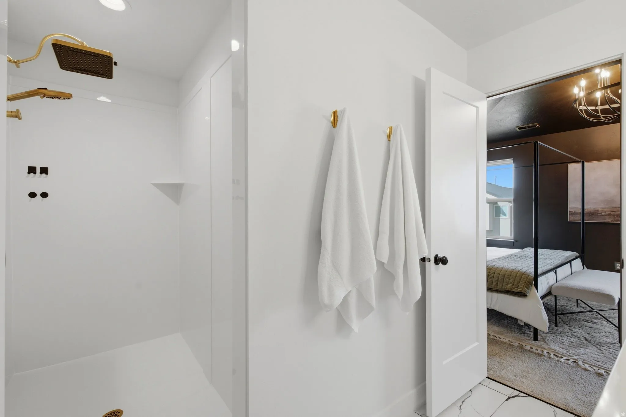 Walk-in shower with upgraded shower head and gold-finish fixtures