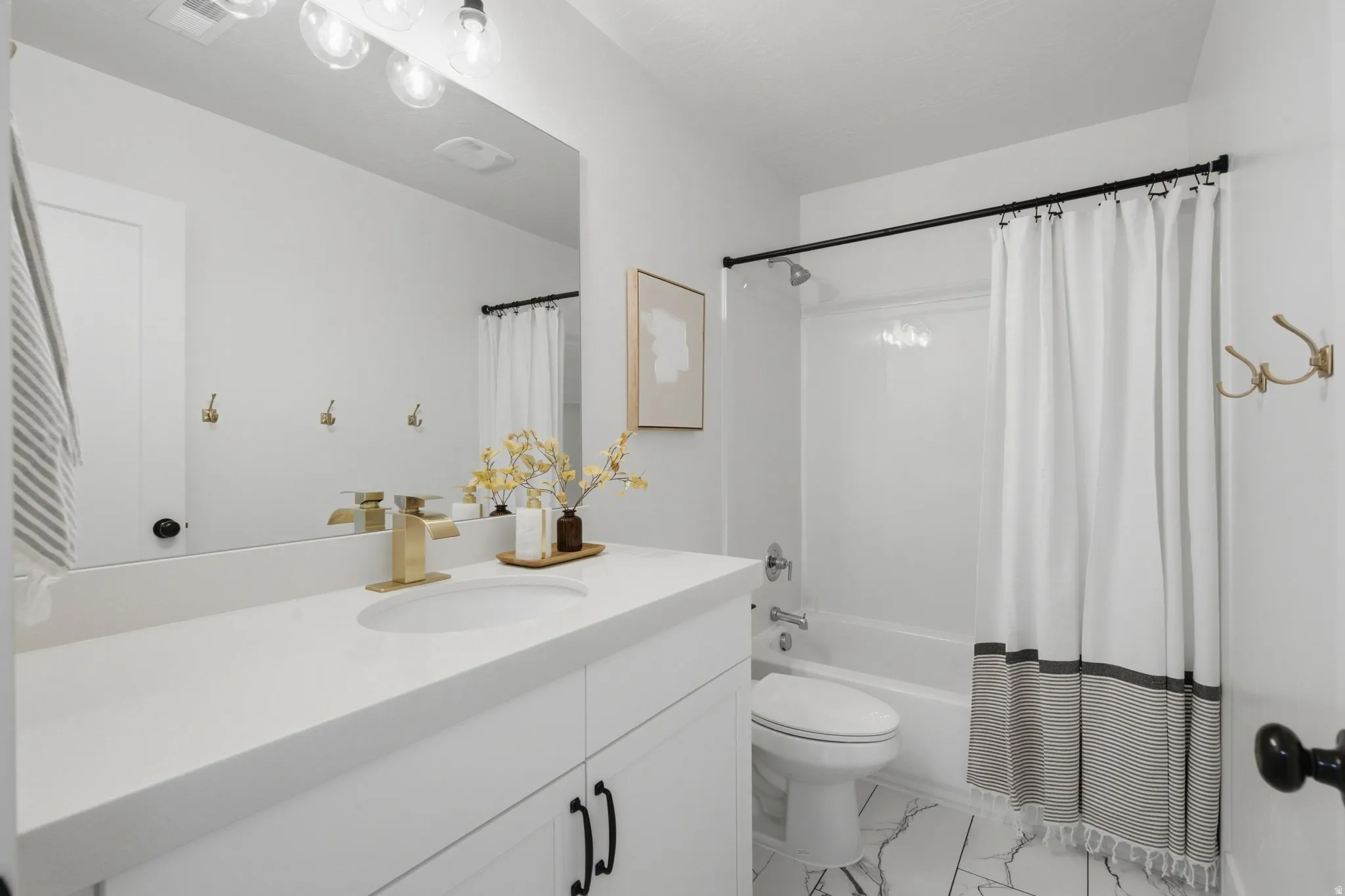 Full Bath with quartz countertops and upgraded plumbing and light fixtures
