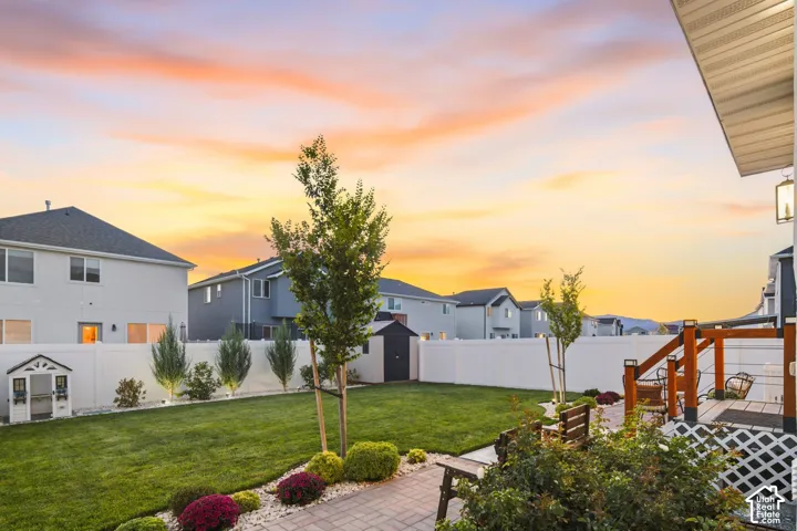 Fully fenced and landscaped back yard with brick paver patios and storage shed