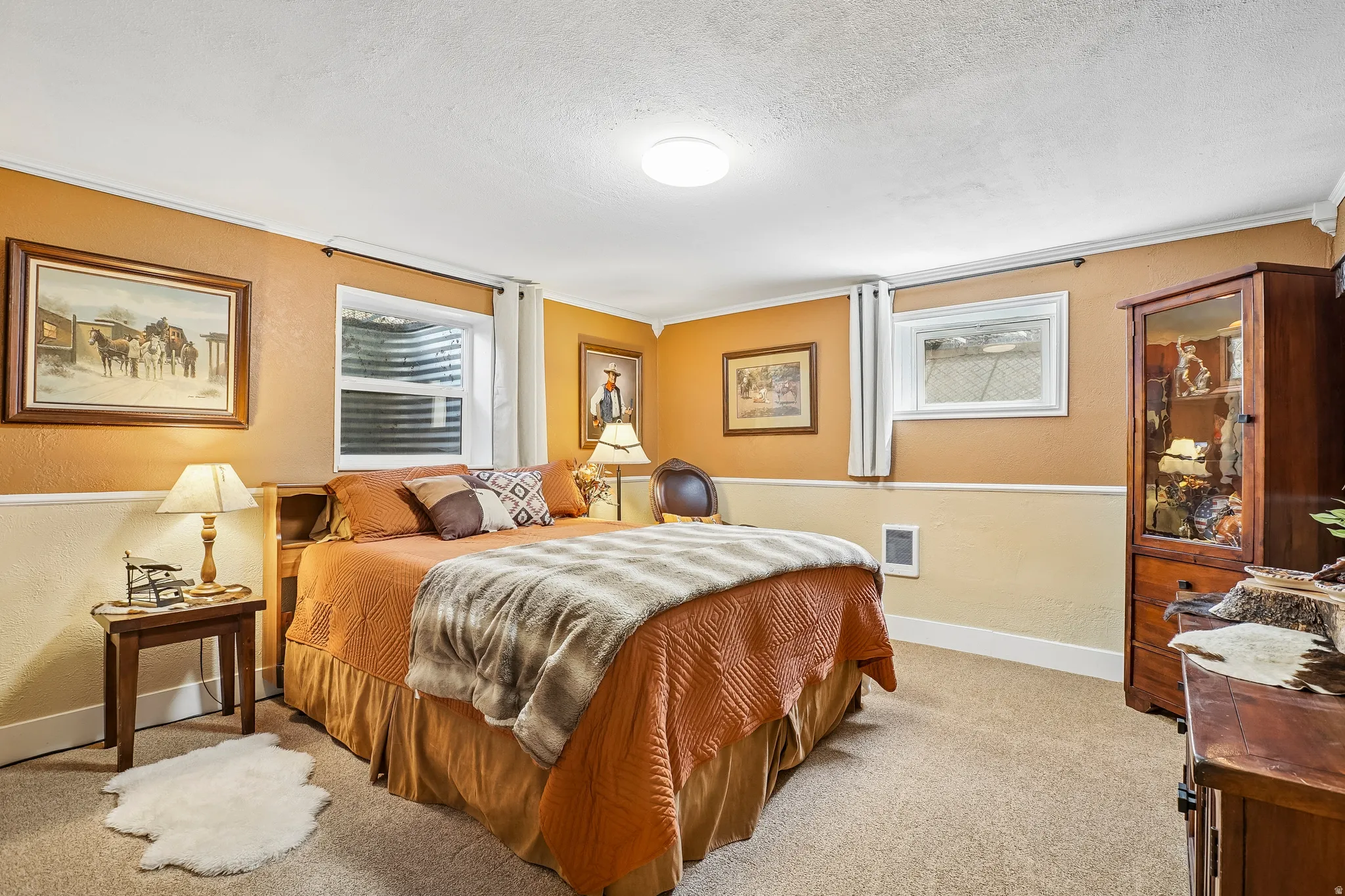 Carpeted flooring, recessed ceiling lighting, two windows with white trim, and a two-tone wall finish