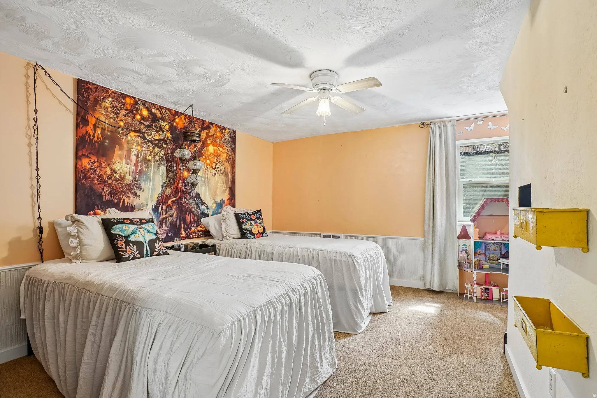 Recessed window, white window treatments, overhead ceiling fan, neutral carpet, and chair rail molding